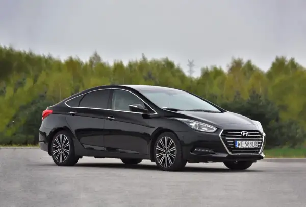 Czarny Hyundai i40 1.7 CRDi na tle drzew. Choć auto prezentuje się elegancko, warto znać jego potencjalne wady przed zakupem.
