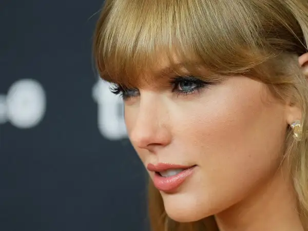 Taylor Swift's profile, with striking blue eyes and blonde bangs, hints at her latest Spotify release.