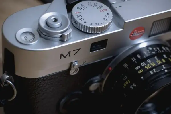 Close-up of a Leica M7 camera, ready for a detailed review. The silver body gleams, showing the "M7" inscription and lens details.