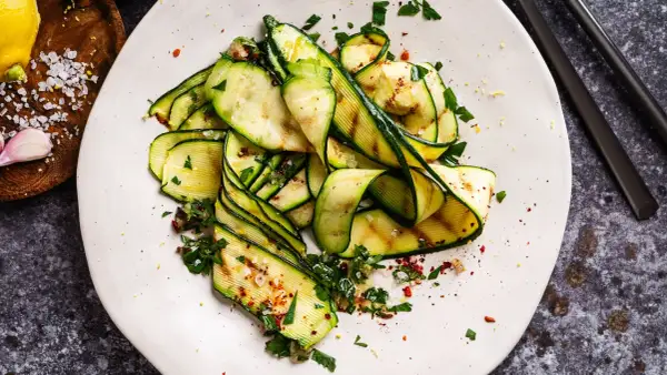 Zucchine grigliate condite con erbe fresche, aglio, sale grosso e peperoncino. Un'idea semplice per gustare le zucchine.