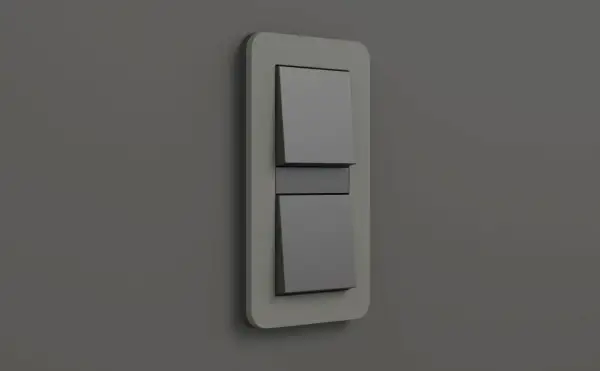 Ein moderner Gira E3 Lichtschalter mit zwei grauen Wippen auf einer hellgrauen Wand.