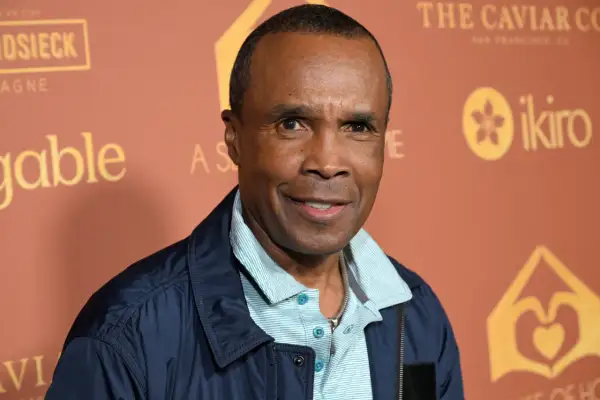 Sugar Ray Leonard, a boxing legend, smiles. His career earnings are a testament to his skill, though his net worth is a separate matter.