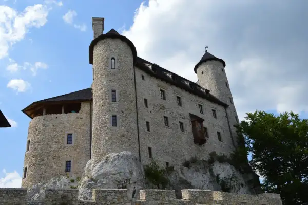 Kamienny zamek na skale, jedna z głównych atrakcji Bobolic, z wieżami i murami obronnymi.