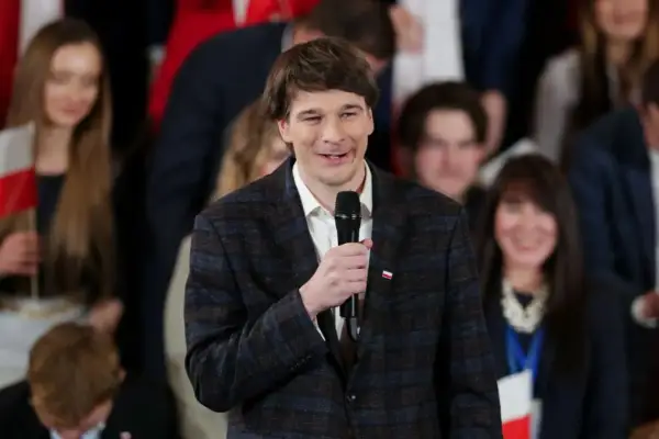 Daniel Nawrocki, którego wiek nie jest widoczny, przemawia do zgromadzonych ludzi.