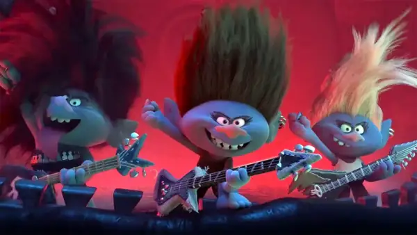 Trzy trolle rockmani grają na gitarach, tworząc głośne trolle piosenki. Ich włosy sterczą, a mina wyraża rock'n'rollową energię.