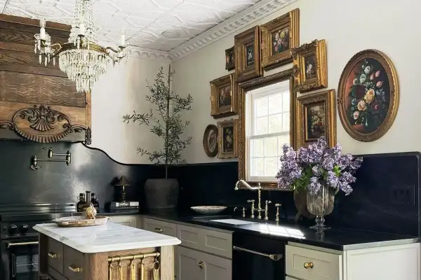 A luxurious kitchen with a crystal chandelier, ornate wood paneling, and a collection of framed floral paintings, evoking the grandeur of Victorian houses.