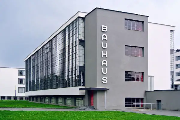 Iconic Bauhaus architecture examples: the Dessau building with its glass curtain wall and prominent "BAUHAUS" lettering.