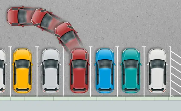 Czerwony samochód manewruje, próbując zaparkować. Wygląda na to, że nie umiem parkować, bo auto jest w dziwnej pozycji.