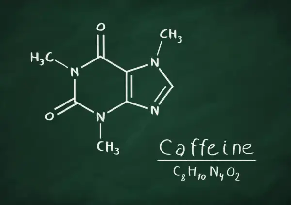 Struktura chemiczna kofeiny, wyjaśniająca, jak kofeina wpływa na organizm. Wzór C8H10N4O2.