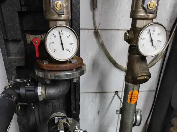 Manometr wskazuje temperaturę ok. 40°C podczas płukania instalacji CO. Widoczne zawory i rury.
