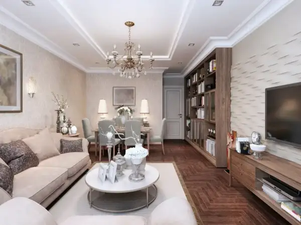 Elegancki salon z jadalnią, gdzie króluje styl w domu. Jasna sofa, kryształowy żyrandol i regał z książkami tworzą przytulną atmosferę.