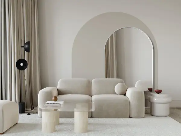 Nowoczesny salon z beżową kanapą i łukiem nad lustrem. Świetny pomysł na łuk w domu, który optycznie powiększa przestrzeń.