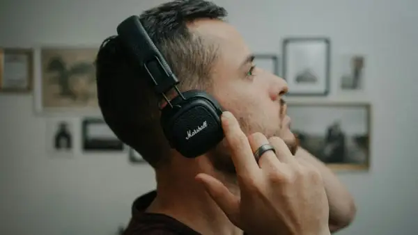 Mężczyzna w słuchawkach Marshall, skupiony na dźwiękach 432 hz.