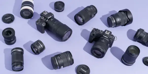 A collection of Canon EOS R cameras and various best L series lenses, including zooms and primes, are artfully arranged on a lavender background.