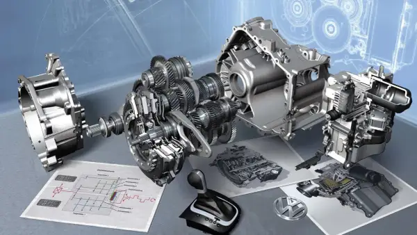 Rozłożona skrzynia DSG z widocznymi biegami, wałkami i schematem technicznym. Obok leży selektor biegów i logo VW.