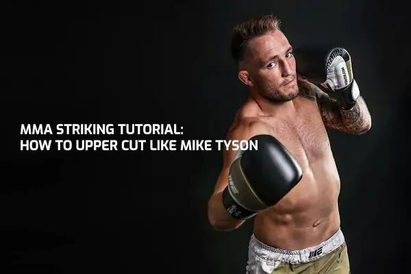 MMA fighter demonstrates a powerful uppercut to the body, channeling the legendary Mike Tyson.