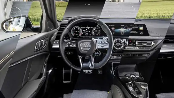 Interni moderni dell'Audi A3: volante sportivo, cruscotto digitale e console centrale con cambio automatico.