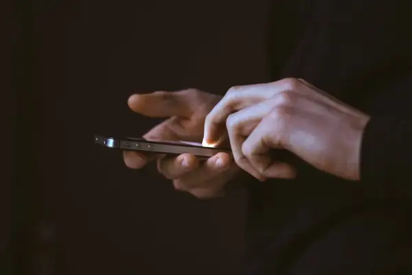Mains utilisant un smartphone, frustrées par une application qui se ferme toute seule sur Android.