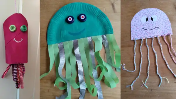Drei bunte Quallen zum Basteln: eine aus einer Toilettenpapierrolle, eine aus einem Pappteller und eine aus Papier mit Garn.