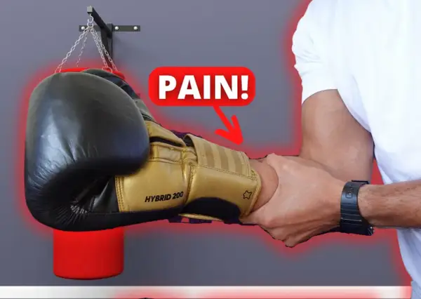 A boxer's forearm is being gripped, with a "PAIN!" graphic and arrow pointing to the wrist. Do strong forearms help you punch harder?