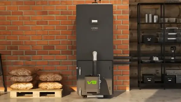 Nowoczesny piec na pellet z zielonym logo, obok palety z pelletem. Dofinansowanie do pieca węglowego może pomóc w zakupie ekologicznego ogrzewania.