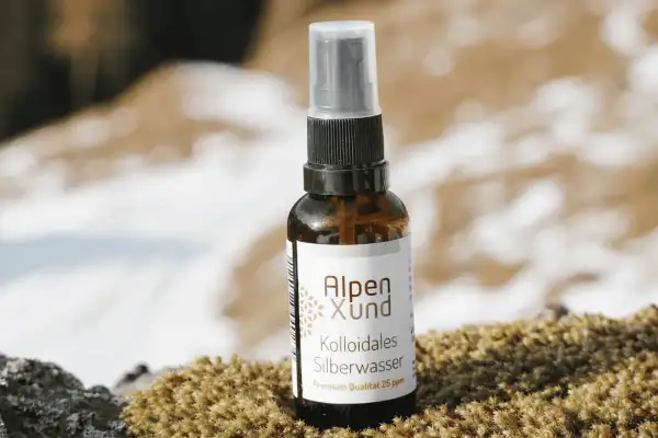 Braune Sprühflasche mit Alpen Xund Kollodiales Silberwasser, Premium Qualität 25 ppm, steht auf Moos.