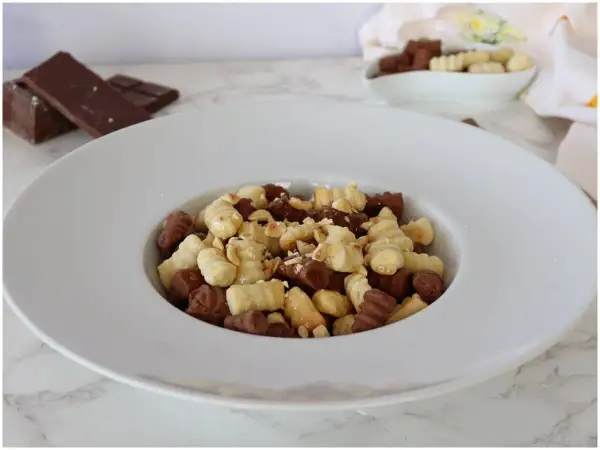 Gnocchi al cioccolato e nocciole, un dolce goloso in un piatto bianco.
