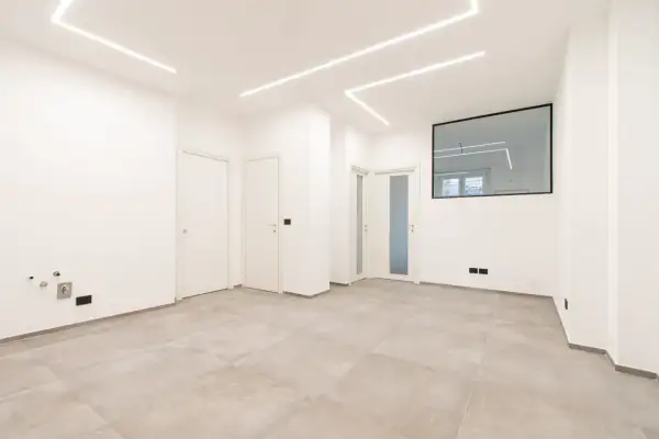 Interno moderno con pavimenti chiari, porte bianche e luci a led sul soffitto. Ideale per chi deve ristrutturare casa e cerca un ambiente luminoso e pulito.