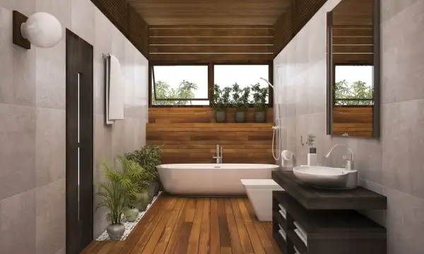 Salle de bain moderne avec baignoire, lavabo et toilettes. Le sol en parquet contraste avec le carrelage mural.