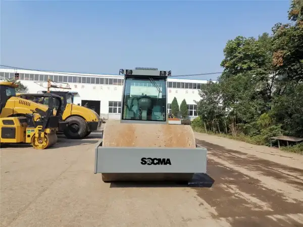 Nowe maszyny do robót ziemnych, w tym walec drogowy SOCMA, czekają na pracę.