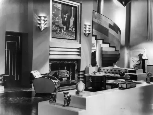 A luxurious Art Deco living room, showcasing the bold geometric style of the era's artists.