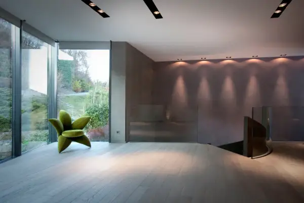 Pavimenti in legno chiaro, ideali come materiali per pavimenti in un ambiente moderno con poltrona verde a forma di fiore.