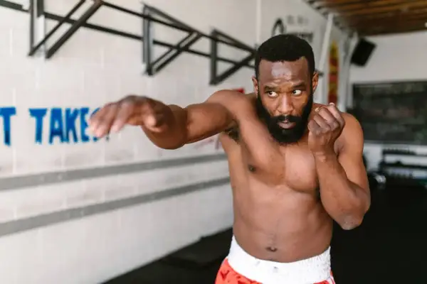 A man practices shadow boxing, demonstrating the physical and mental shadow boxing benefits.