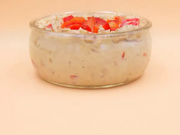 Pyszna pasta z tuńczyka z kawałkami papryki w szklanym naczyniu.