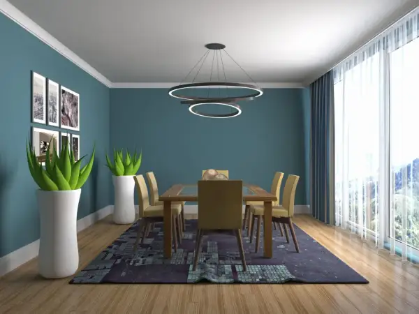 Salle à manger moderne avec table en bois, chaises jaunes et tapis graphique. Le plafond blanc lumineux donne une impression de grandeur, une astuce pour agrandir la pièce.