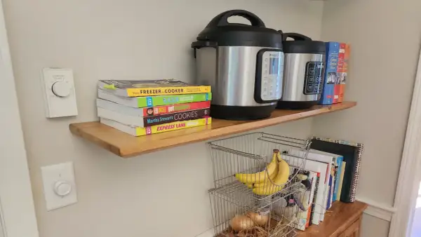 DIY floating shelves hold Instant Pots, cookbooks, and bananas.