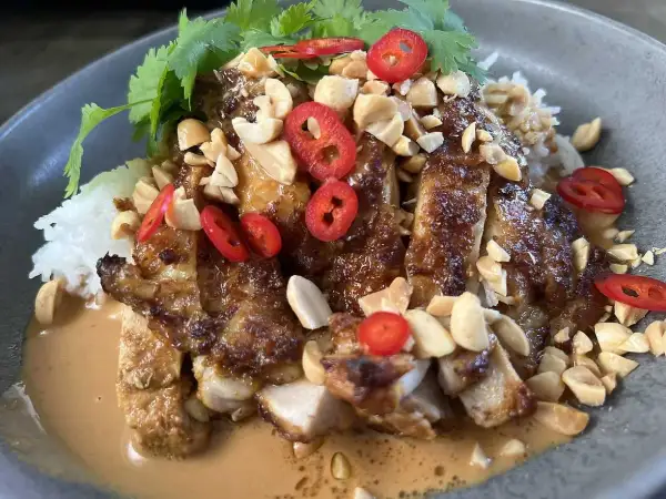 En läcker kyckling satay med ris, jordnötter, chili och koriander i en krämig jordnötssås.