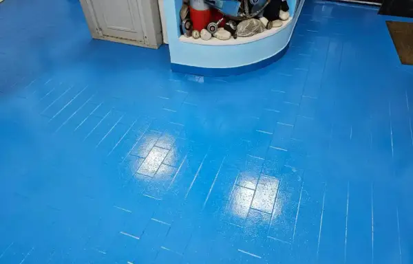 Pavimento blu brillante, effetto parquet, appena finito di lavorare la resina. Riflessi luminosi sulla superficie liscia.