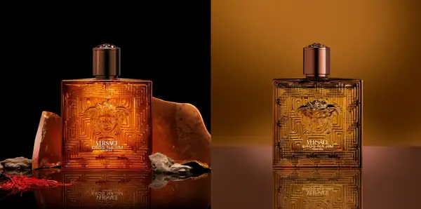 Złota butelka Versace Eros Parfum, otoczona kamieniami i szafranem, emanuje luksusem.