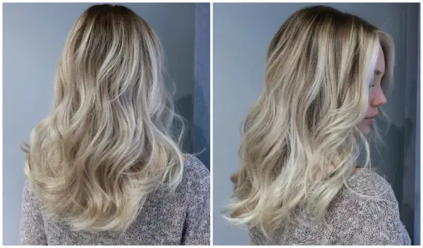 En kvinna med vackert, vågigt hår i en "old money blonde"-nyans. Håret har en naturlig, solkysst look med ljusa slingor.