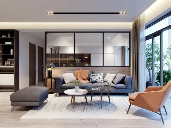 Soggiorno moderno con divano grigio, poltrona color terra e tavolini. Idee originali per arredare casa con stile e comfort.