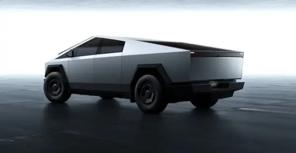 Futurystyczny Tesla Cybertruck w kolorze srebrnym, z ostrymi krawędziami. Zastanawiasz się nad jego tesla cybertruck cena?