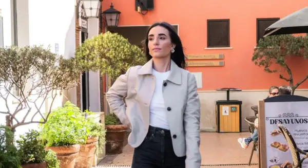 Mujer con chaqueta clara y vaqueros oscuros, lista para un outfit de Semana Santa.