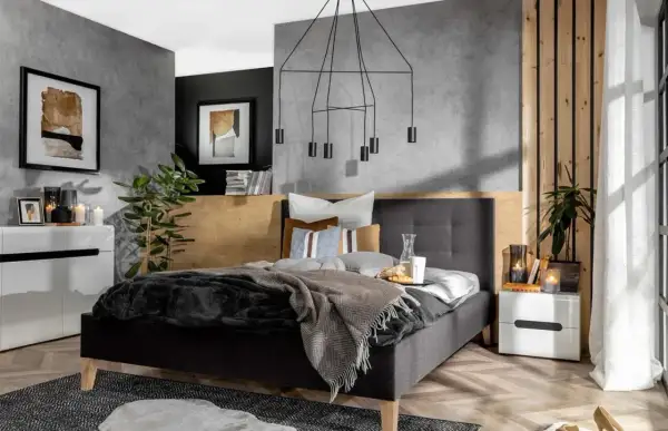 Nowoczesna, szara sypialnia inspiracje. Betonowa ściana, drewniane akcenty i minimalistyczne meble tworzą przytulną atmosferę.