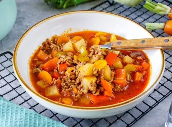 Herzhafte Hackfleisch-Gemüse-Suppe, perfekt für rezepte ohne kohlenhydrate. Mit Kartoffeln, Karotten und Paprika in würziger Tomatenbrühe.