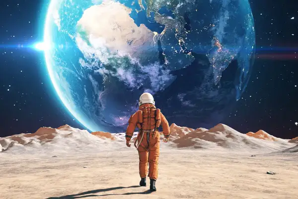 Samotny astronauta na Księżycu podziwia Ziemię.