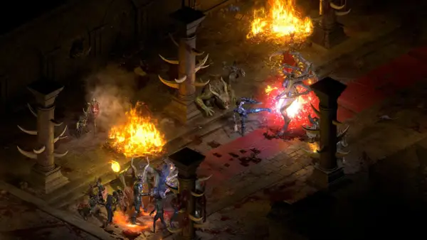 Wojownicy walczą z potworami w płomieniach i mroku, to scena z diablo 2 resurrected patch.