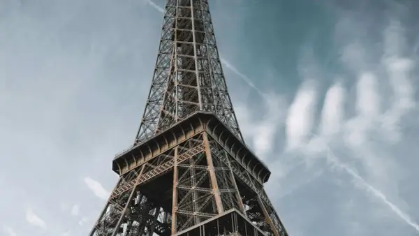 La **Eyfel Kulesi** se dresse fièrement sous un ciel bleu parsemé de nuages.