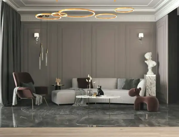Nowoczesny salon z szarą kanapą, designerskim fotelem i okrągłym stolikiem. Elegancki styl wnętrz podkreślają złote lampy i marmurowe detale.