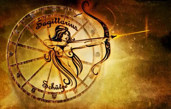Znak zodiaku Strzelec, symbolizowany przez łucznika z łukiem i strzałą, w złotej oprawie zodiakalnego koła.